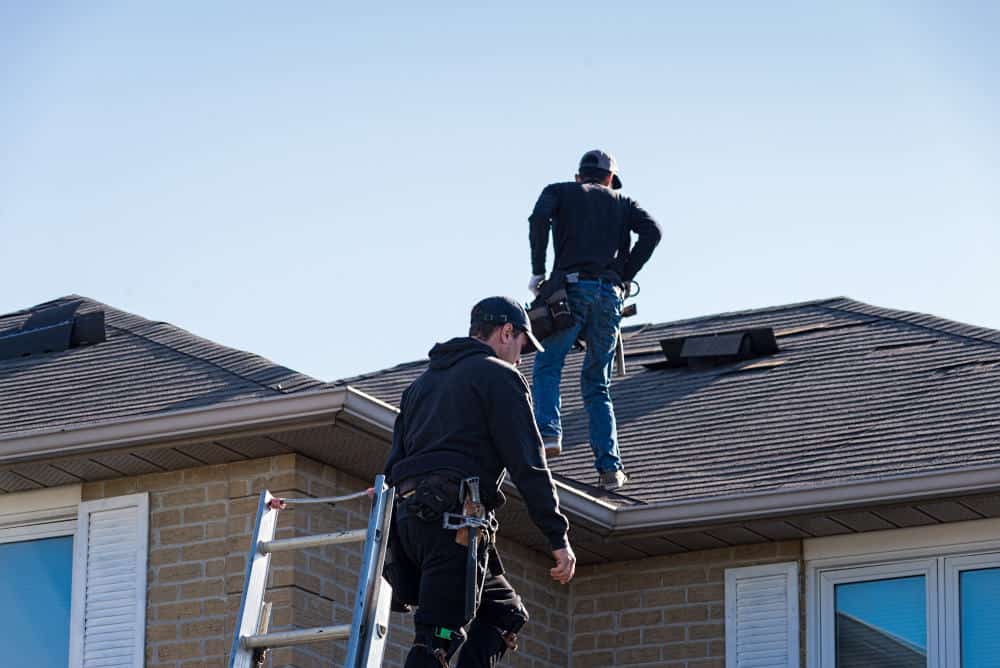 Roofers inspecting a roof in Columbia SC