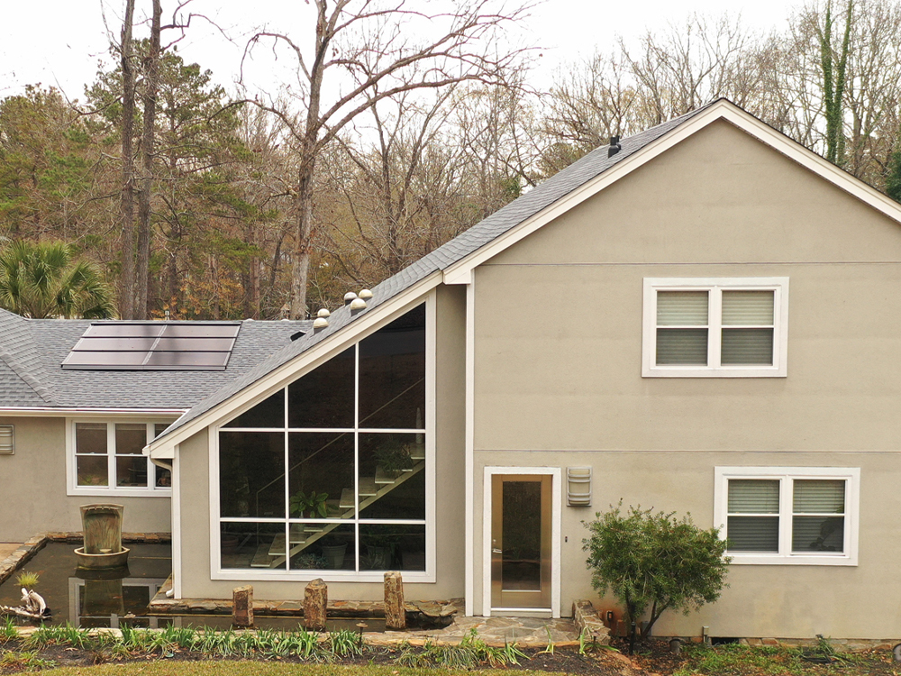 we-love-odd-windows Exterior of a home with large floor-to-ceiling picture windows beside smaller windows.