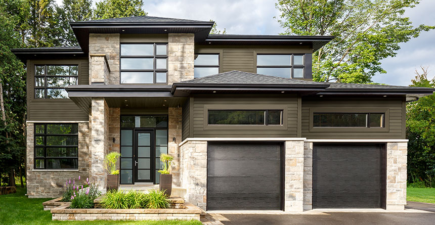 Contemporary home with stone accents and dark horizontal siding.