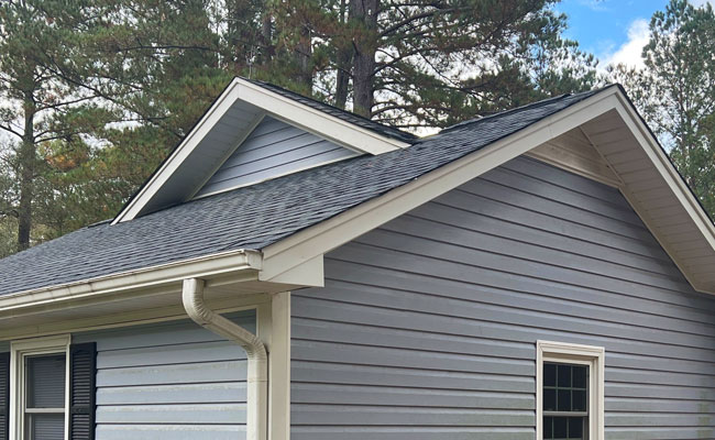 Restored gable and roof after roof repair with new shingles installed.