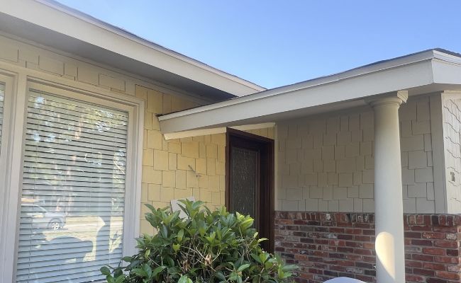Picture windows on a white house.