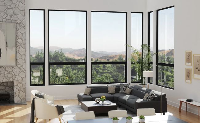 simonton-color-laminate-windows-installed-near-me-south-carolina Modern living room with floor-to-ceiling black window frames offering scenic mountain views.